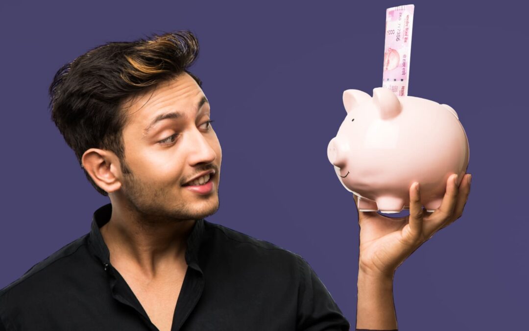 Happy young man looking at a piggy bank to show benefits of investing at a young age